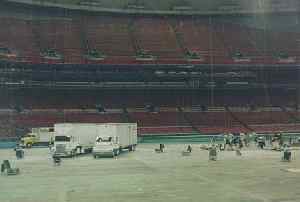(Photo: Floor of 
Seattle's Kingdome, nearly empty save for a few 40-foot semis and some 
stagehands)